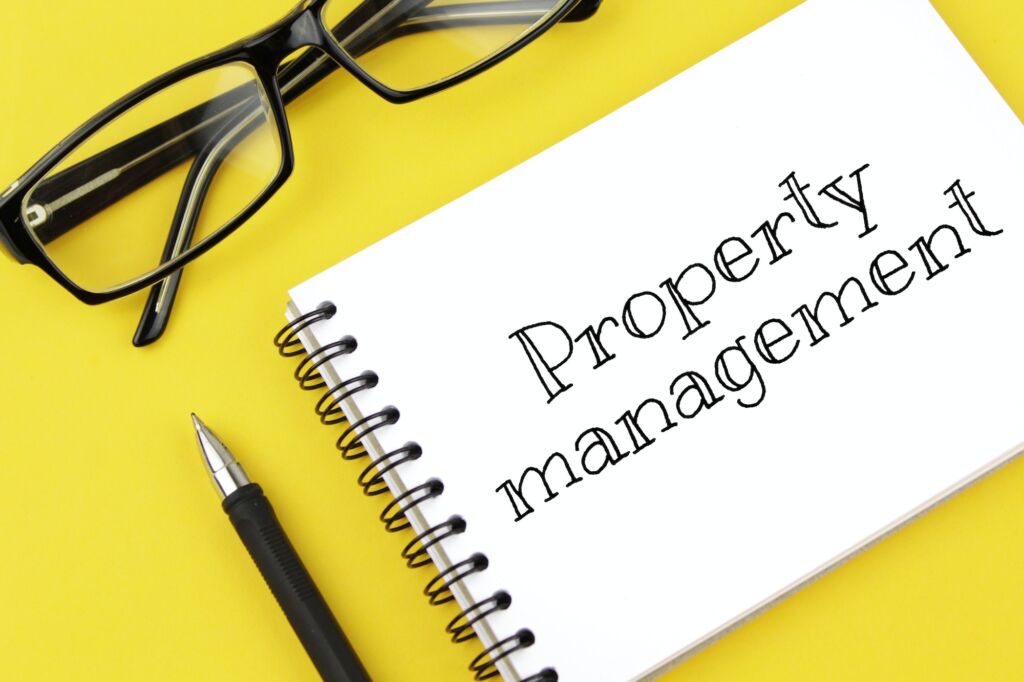 blank paper with inscription property management on a yellow background