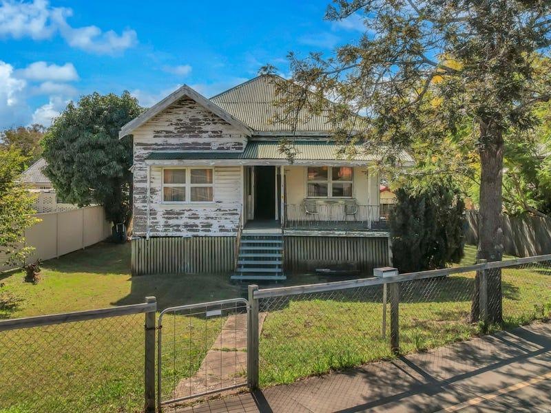Older Australian timber house with weathered exterior, raised foundations, front porch and overgrown garden, illustrating an ageing property that may require significant maintenance and renovation.
